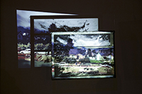 Artwork by ChristopherPaulJordan_Image of landscape with cars and houses projected on a window frame.