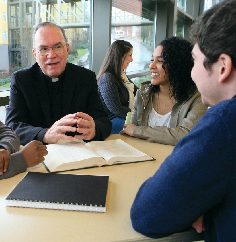 Father Steve chats with a group of students