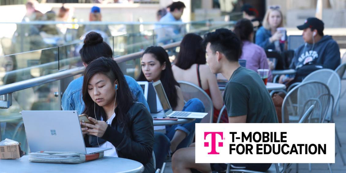 T Mobile logo overlayed on photo of students on campus with laptops