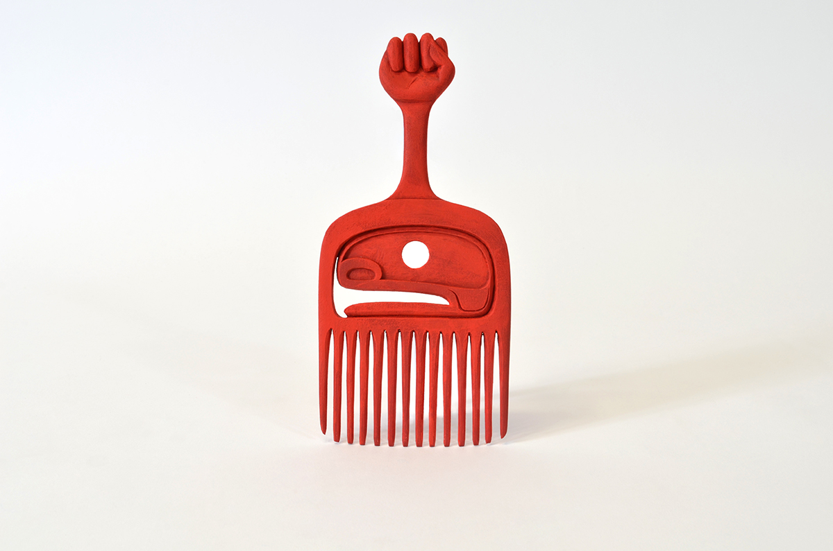 Image of red comb carved by artist Dean Hunt
