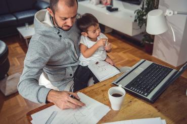 Father working from home with child