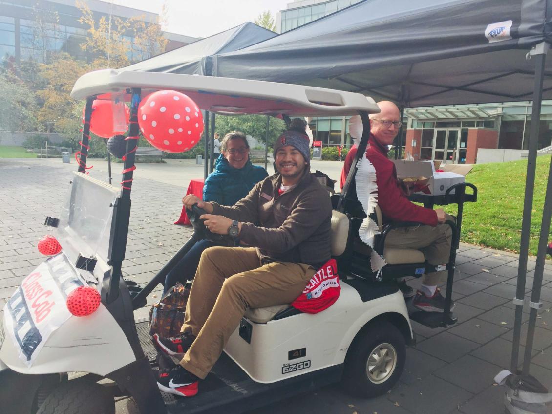 People sitting in a golf cart