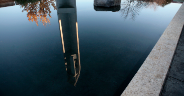 the reflection pool outside the Chapel of St Ignatius with a reflection of the cross and belltower in the water