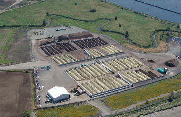An arial image of a compost facility with multiple piles of compost.