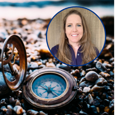 Image of Kira Mauseth with compass on a rocky beach