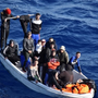 Refugees in small boat at sea