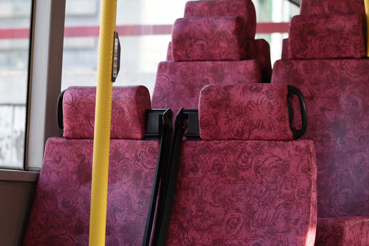 photograph of bus seats in the daylight