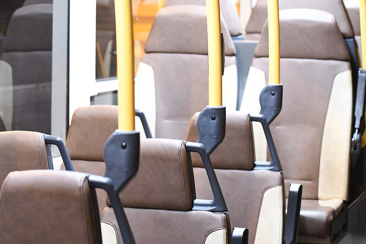 photograph of the interior of a bus with empty seats