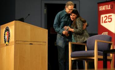 Fr. Pat Twohy & Dr. Christina Roberts, Director of IPI hugging on stage