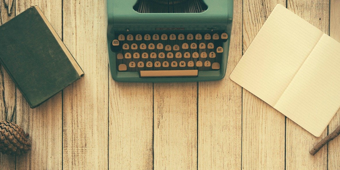 Public relations, communications, journalism, advertising - Old green typewriter on weather-worn desk