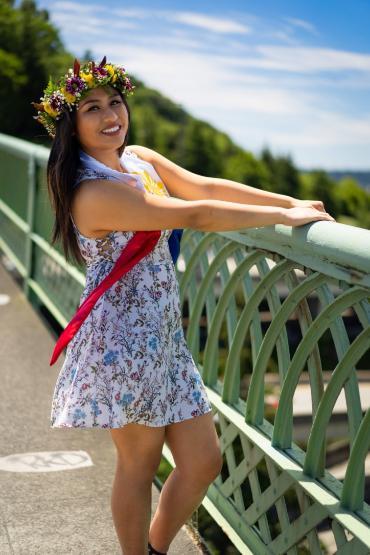 Student posing for photo on a bridge