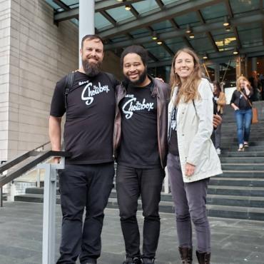 Showbox employees and organizers Nick Fillhart, Earnie Ashwood, and Shannon Welles on the steps of City Hall following the Landmark designation