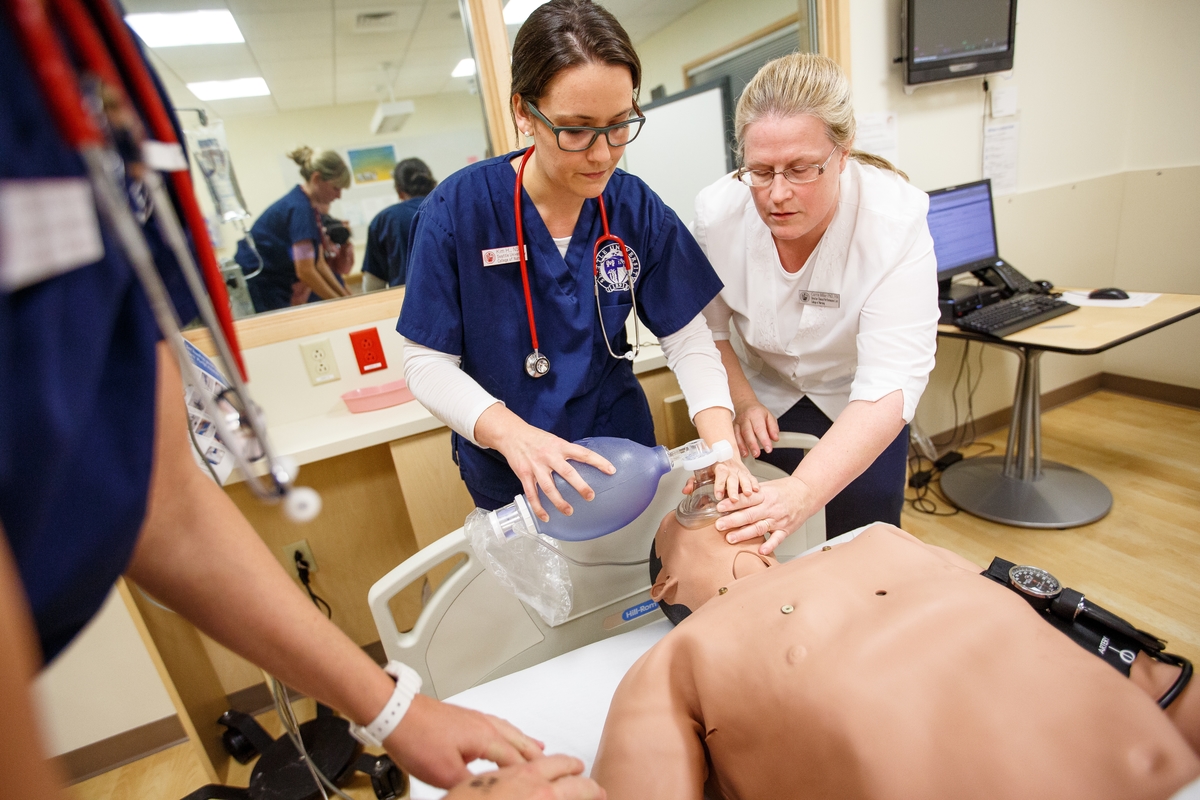 A scene where students are practicing CPR with high fidelity manikins in the Clinical Performance Lab
