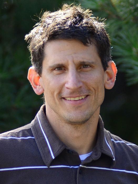 Headshot of white man with short brown hair smiling