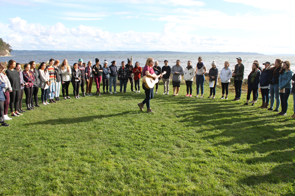 Group of students standing in a circle at the New Student Retreat
