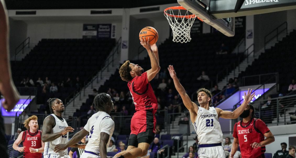 Men's basketball player goes for the hoop