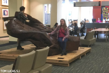 Students sitting on the Bird in Flight sculpture