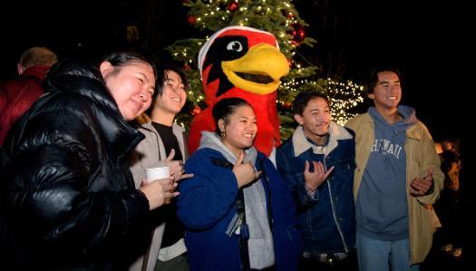 Students celebrating the tree lighting with Rudy