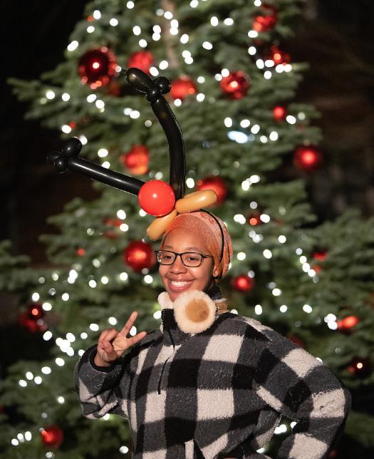 Student wearing reindeer hat at tree lighting