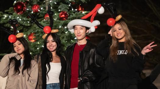 Four students with Santa hats at lighting