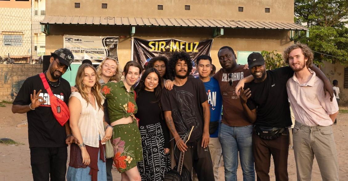 Photo featuring SU study abroad students with rappers in Senegal