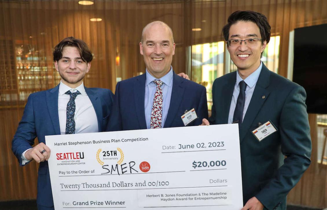 Professor Shen Ren with check from winning Business Plan Competition