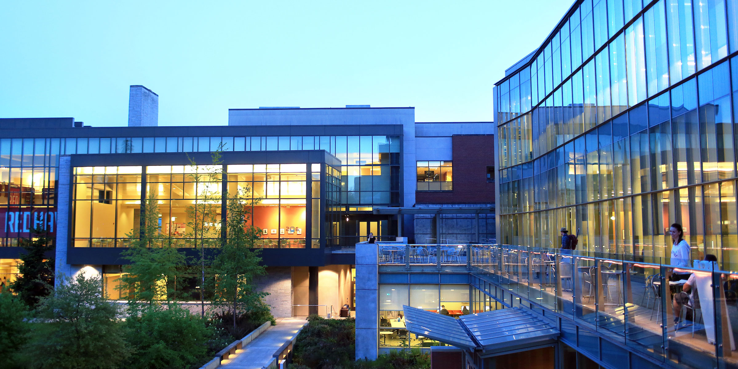warm glow of the Student Center cafeteria and library at dusk