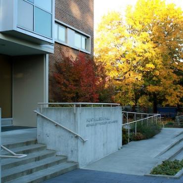 The entrance to Hunthausen hall with vibrant fall trees in the background