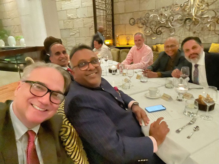 Eduardo Peñalver and others smiling at a dinner table