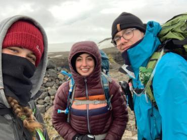 Three people in winter hiking gear.