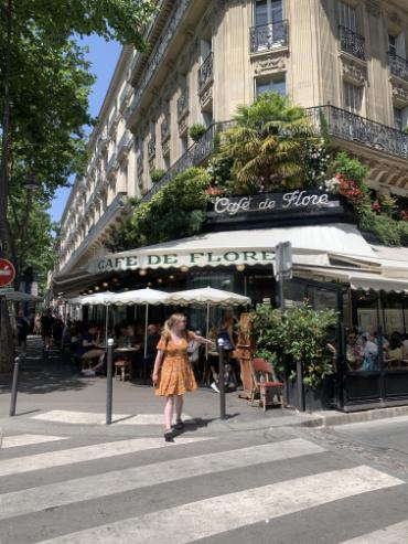 A person in front of a cafe.
