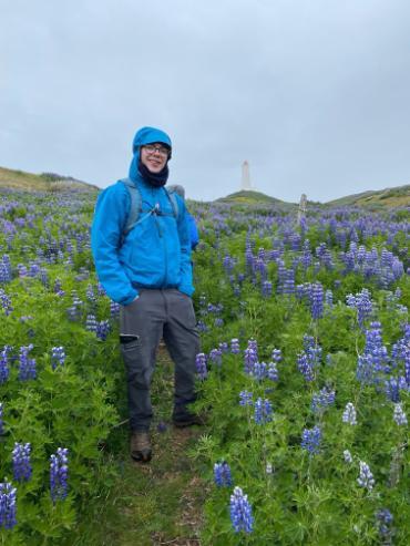 A student surrounded by flowers