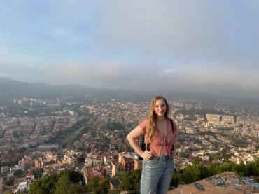 A person standing in front of a view of Barcelona