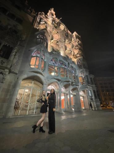 Two people standing in front of a building
