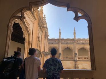 Three people looking out of a balcony