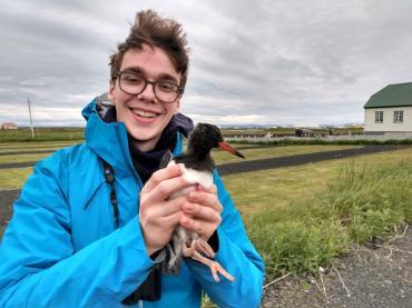 A student holding a bird