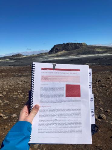 A notebook in front of rocky landscape