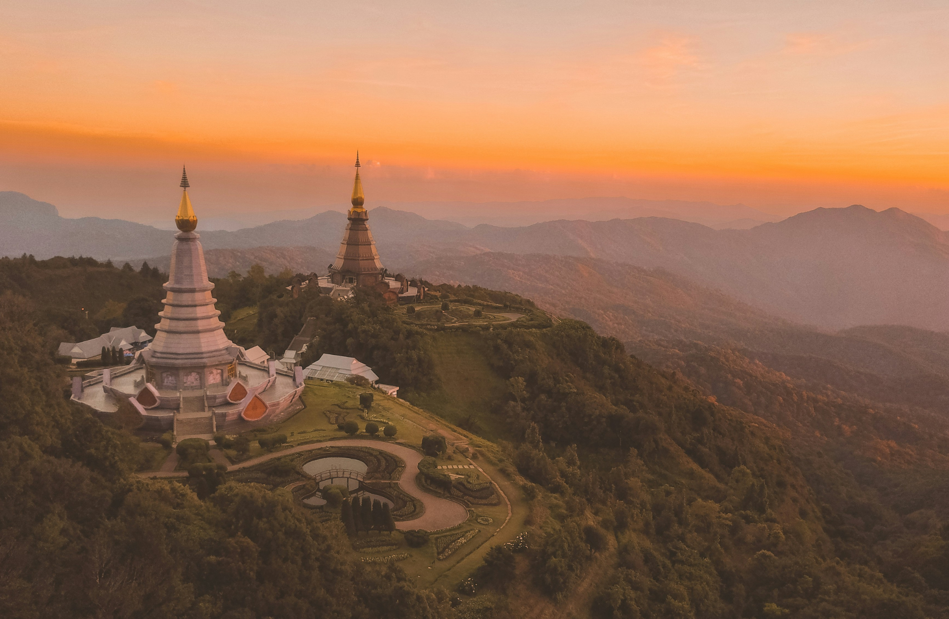 sunset of a Thai temple along a mountain range