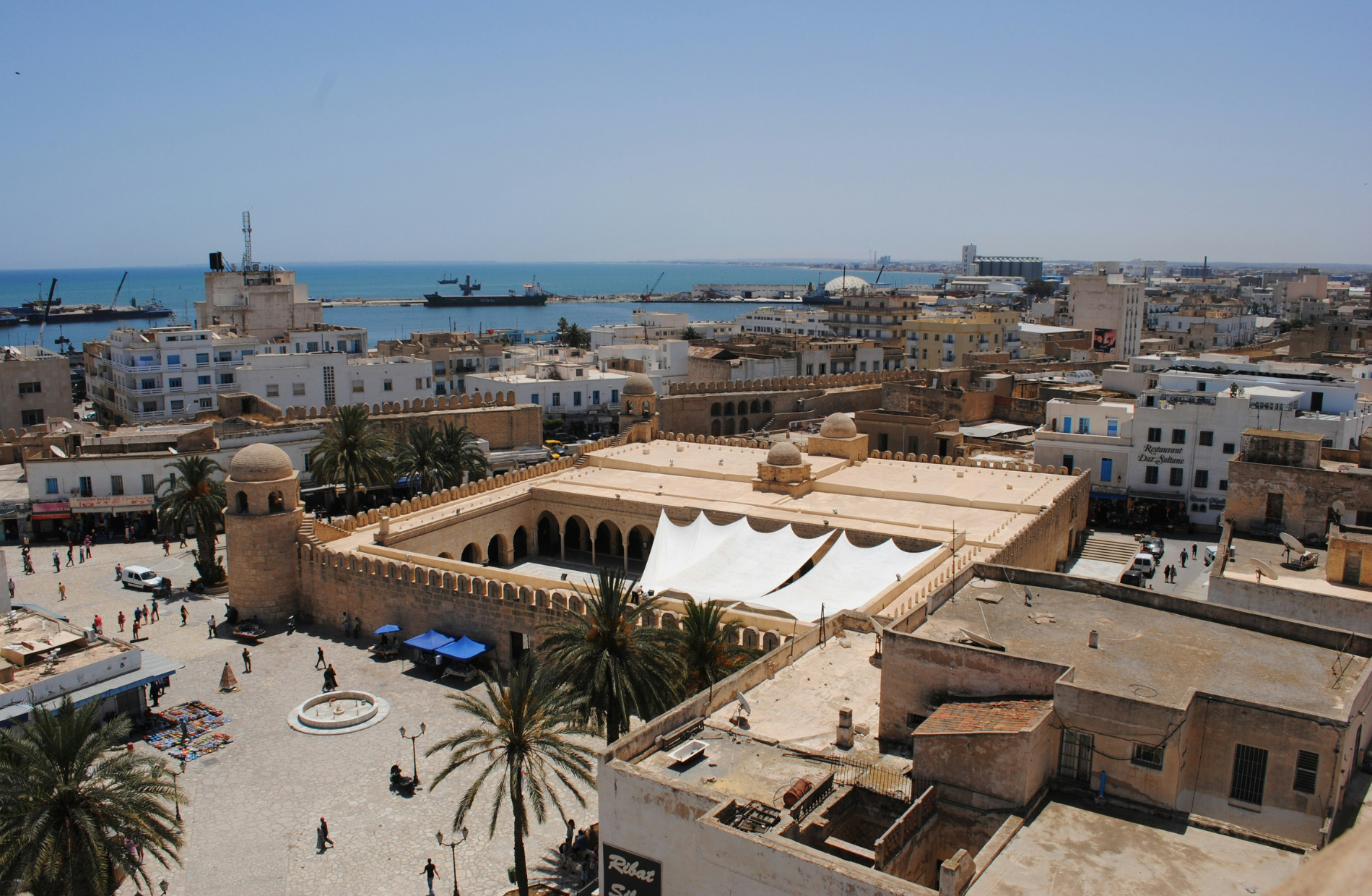 aerial view of a large mosque with the harbor in the background