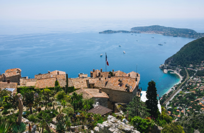 A castle overlooking a body of water surrounded by trees