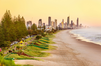people on beach with high rise buildings in the distance during daytime