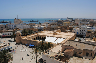 aerial view of a large mosque with the harbor in the background