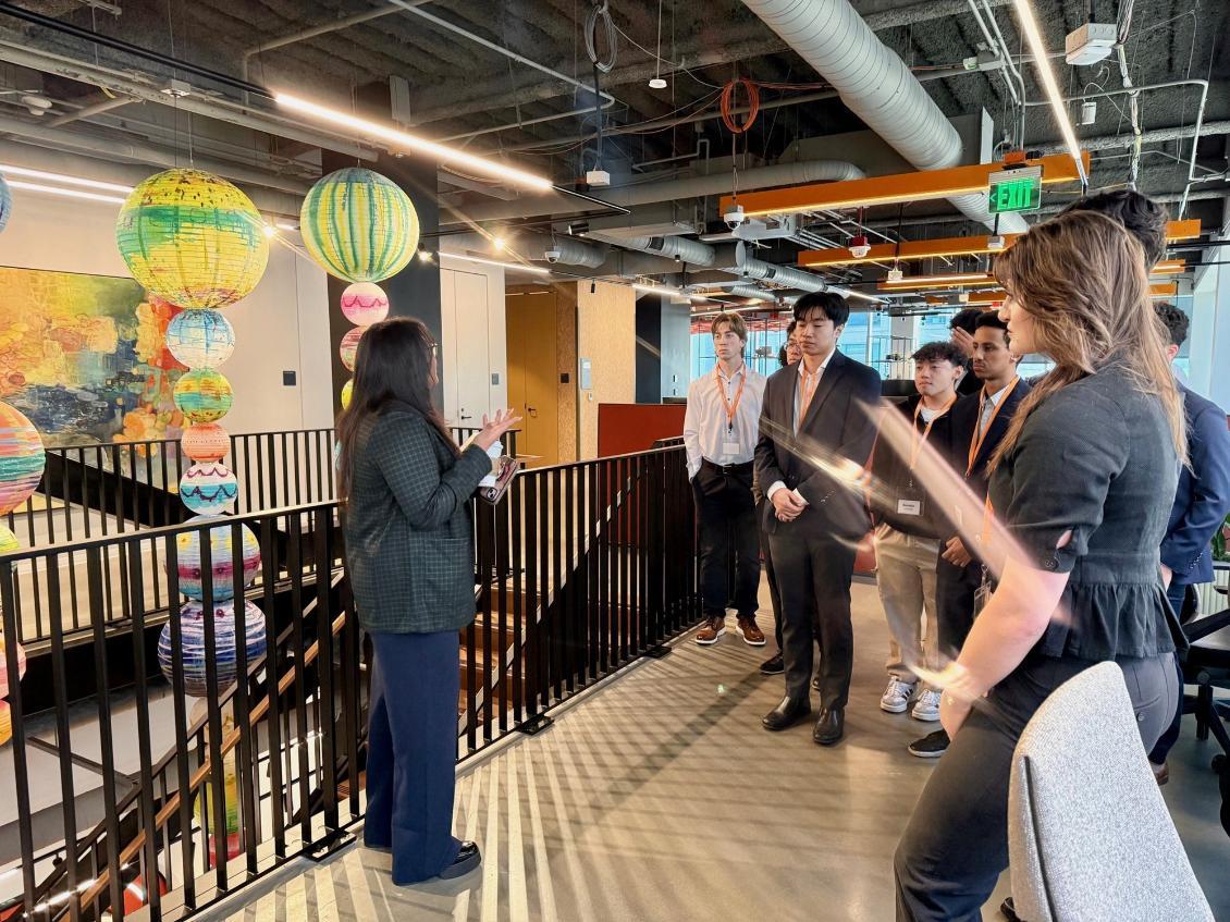 A Deloitte host speaks with a group of Albers students during a company trek to Deloitte in January 2026.