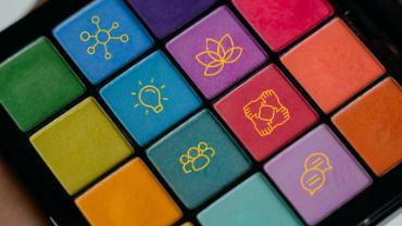 Paint tray with bright watercolors, overlayed with Seattle University's career readiness icons