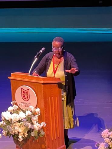 Woman speaking in front of podium