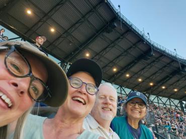 MAP faculty and staff smiling at Mariner's game