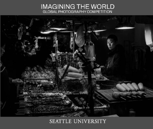 a cover of the imagining the world book with a photo of a man at a market