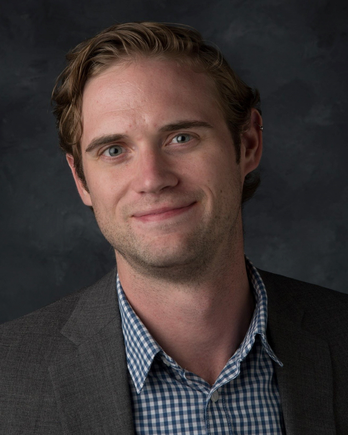 a man in front of of a backdrop