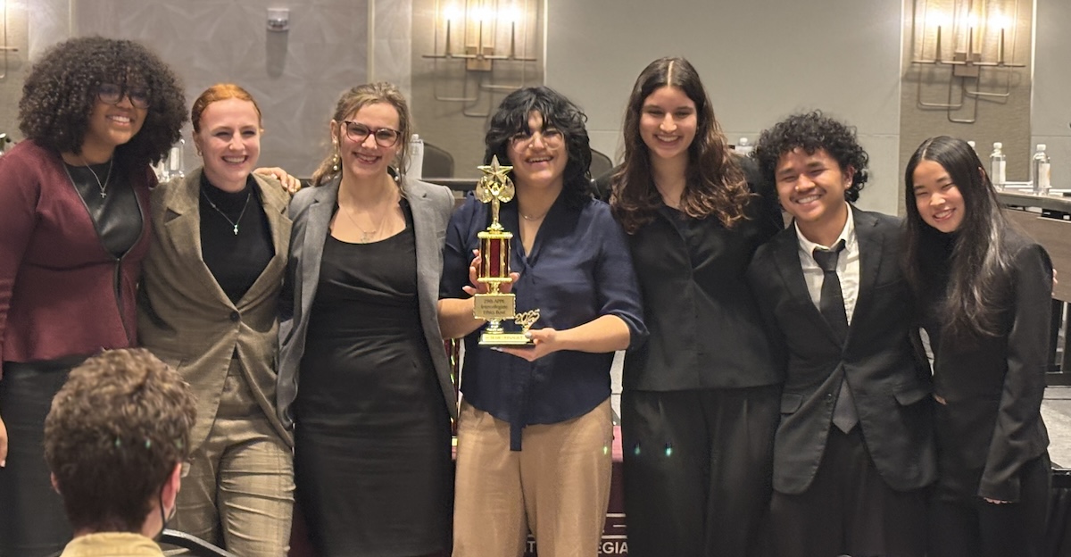A photo featuring Ethic Bowl winners with trophy
