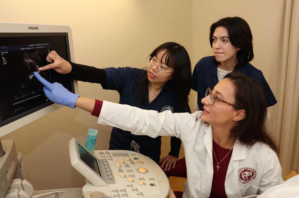 Nursing students and a professor view and ultrasound
